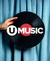 Hand holding a vinyl record with 'UMUSIC' logo against a blue curtain background